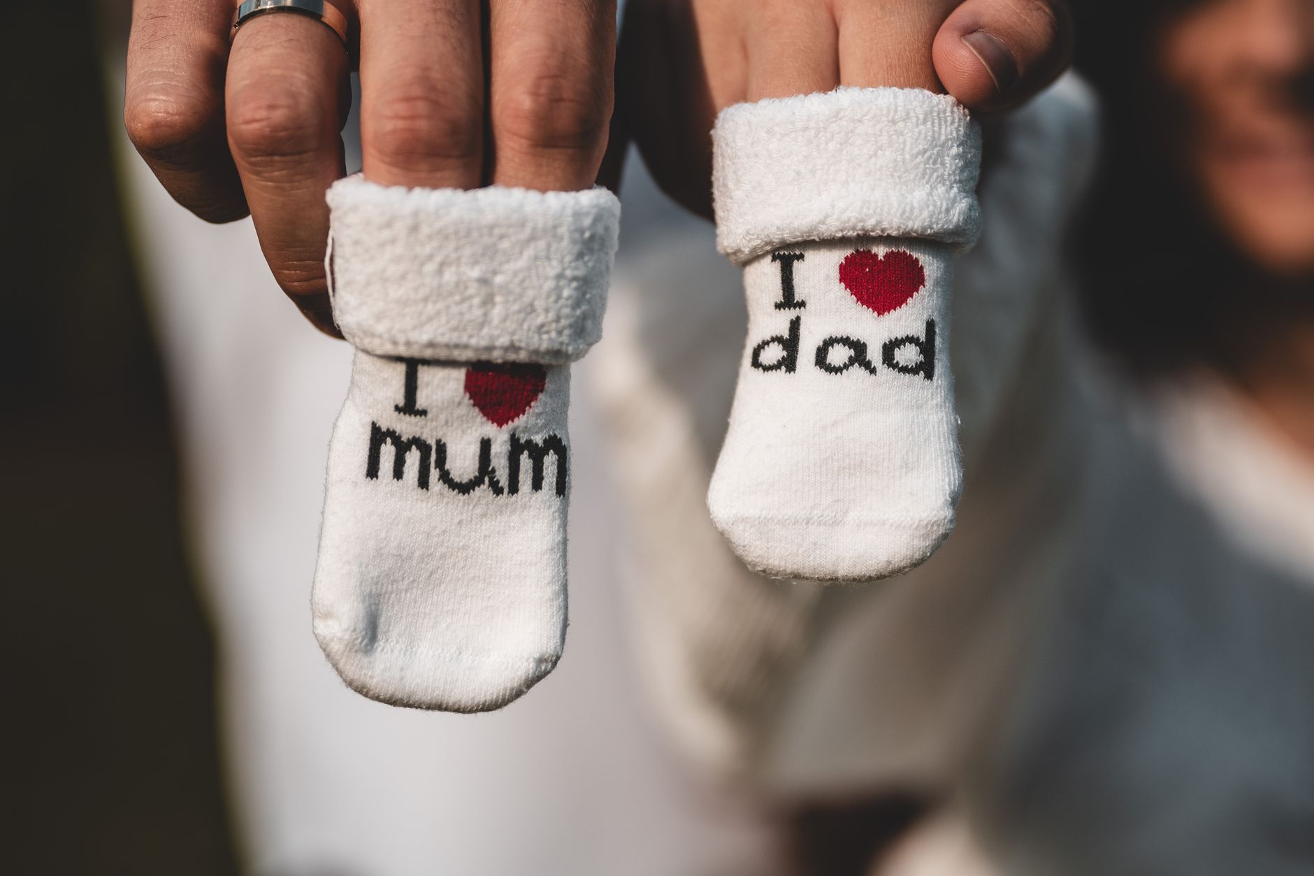 cute baby socks held by parents hands